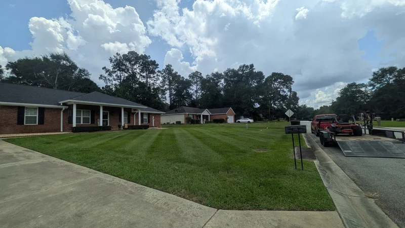 Freshly mowed residential lawn with clean stripes