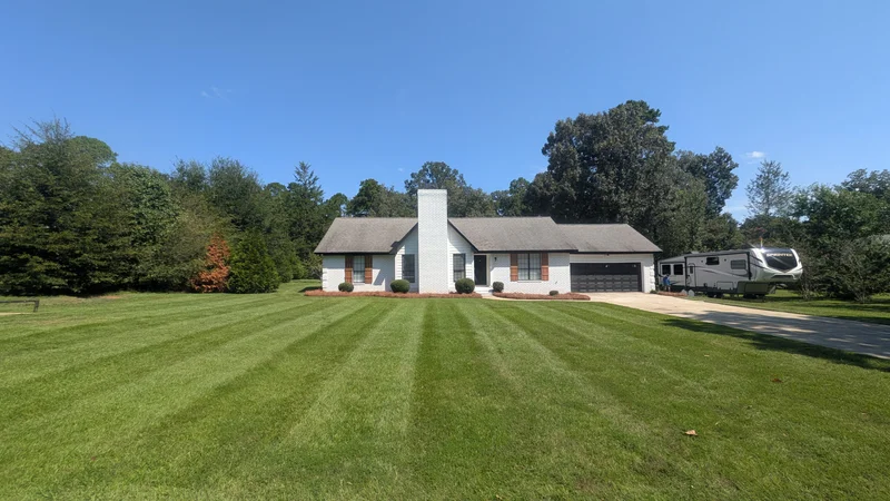 Freshly striped lawn in front of a white home